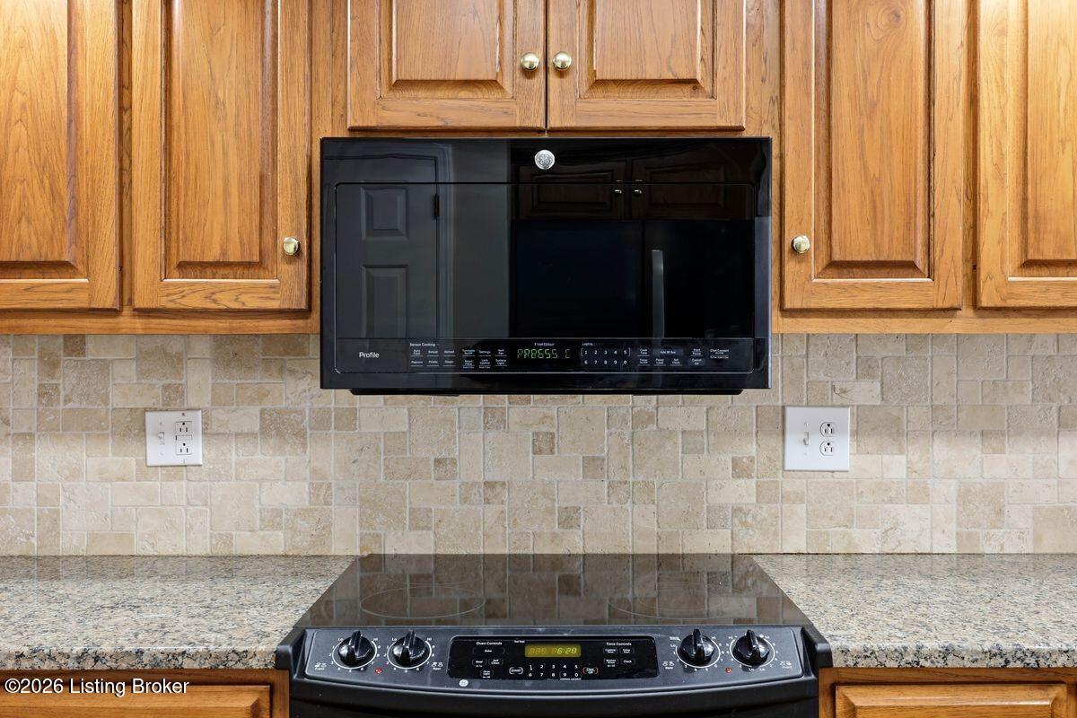 7719 Hermits Run Road Louisville, KY 40291 - Photo 17 of 54 Stone tile backsplash, glass cooktop, above stove microwave