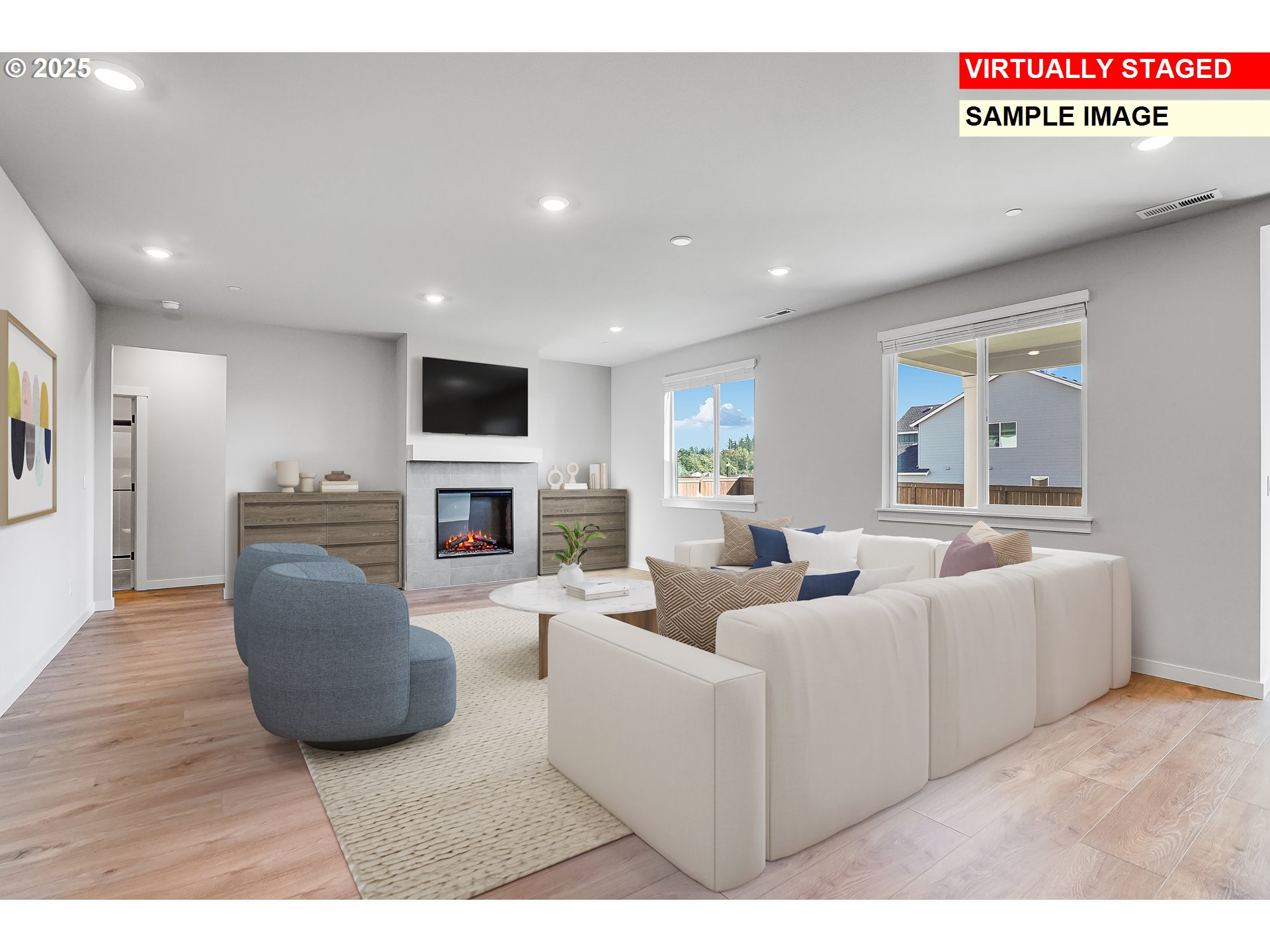 5486 North 88th Avenue Camas, WA 98607 - Photo 10 of 28 a living room with furniture a fireplace and a flat screen tv