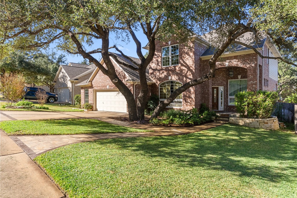 2932 Grimes Ranch Road Austin, TX 78732 - Photo 1 of 38 a front view of a house with a yard