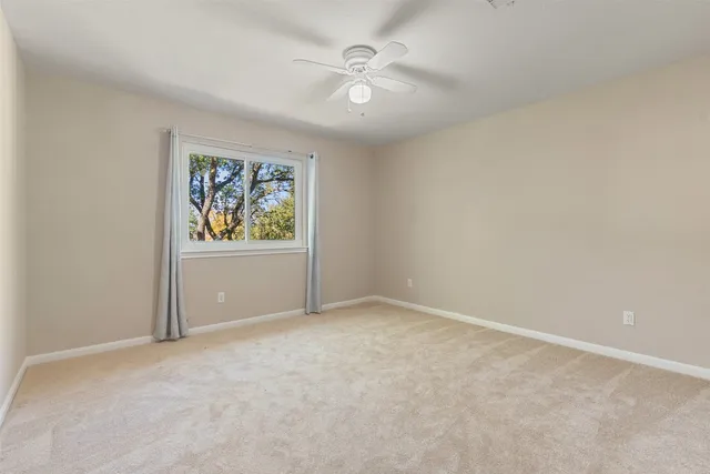 an empty room with windows and furniture