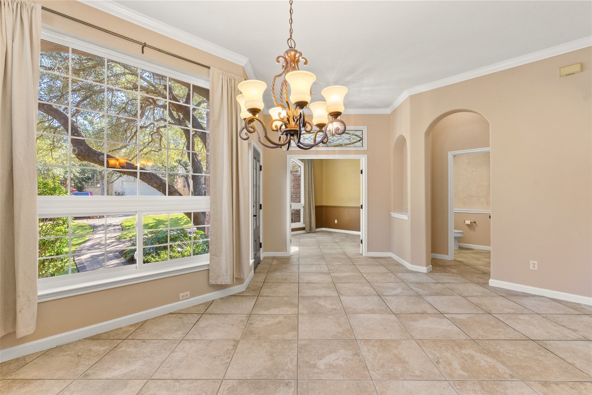2932 Grimes Ranch Road Austin, TX 78732 - Photo 19 of 38 a view of a room with window and chandelier