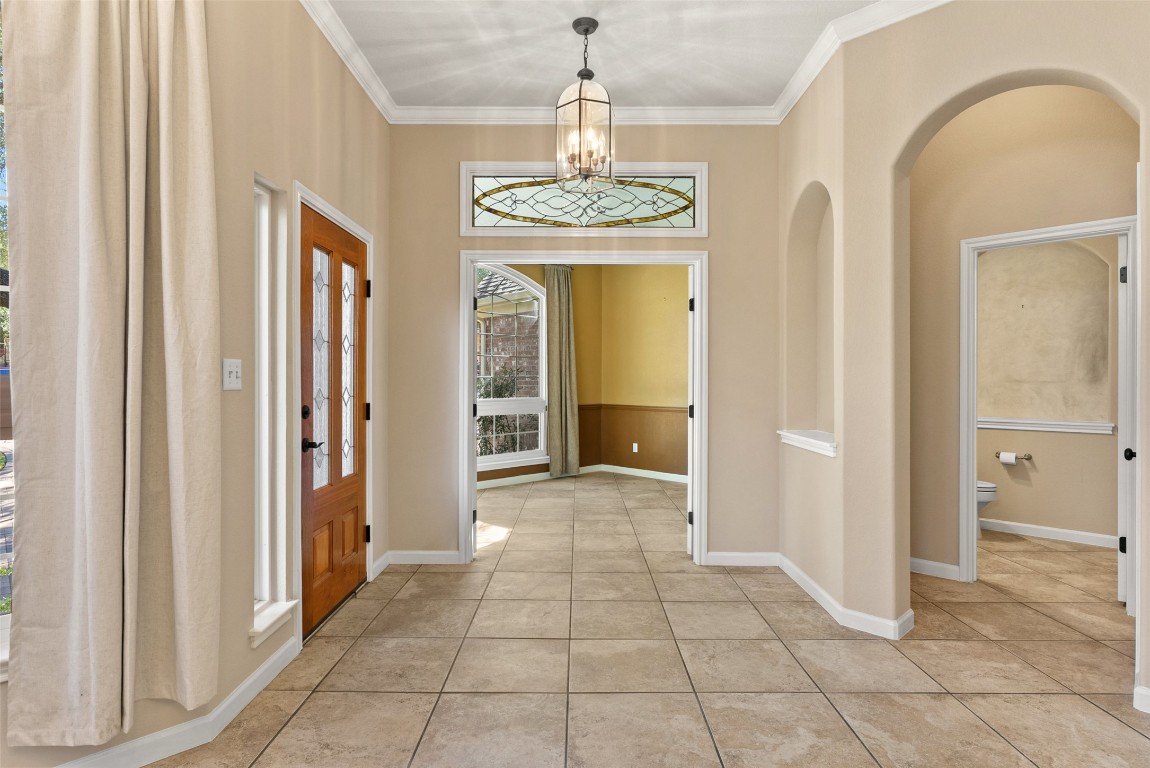 2932 Grimes Ranch Road Austin, TX 78732 - Photo 20 of 38 a view of a hallway with windows and chandelier