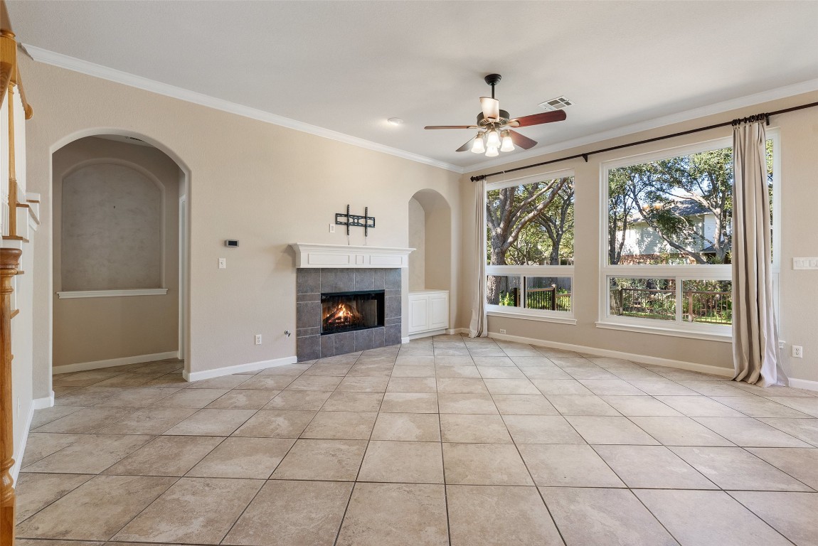 2932 Grimes Ranch Road Austin, TX 78732 - Photo 22 of 38 a view of an empty room with a fireplace and a window