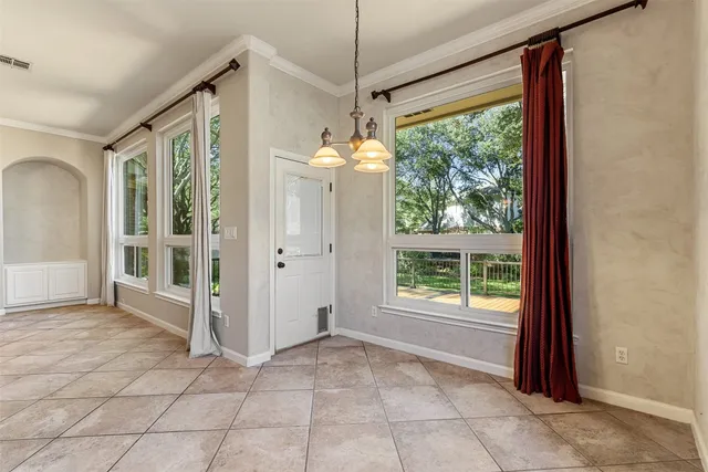 a view of a room with window and front door