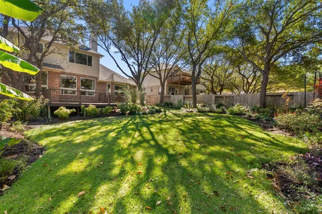 a brick house with trees in front of it