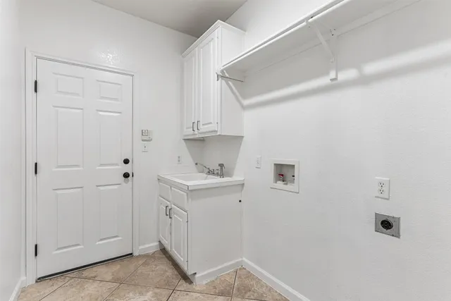 a utility room with cabinets washer and dryer