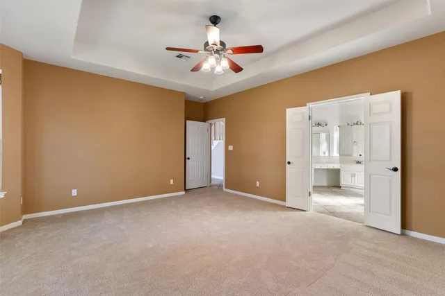 a view of an empty room with a ceiling fan