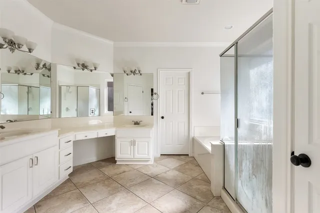 a spacious bathroom with a shower sink and mirror
