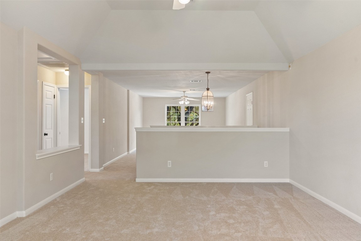 2932 Grimes Ranch Road Austin, TX 78732 - Photo 10 of 38 an empty room with kitchen view and wooden floor