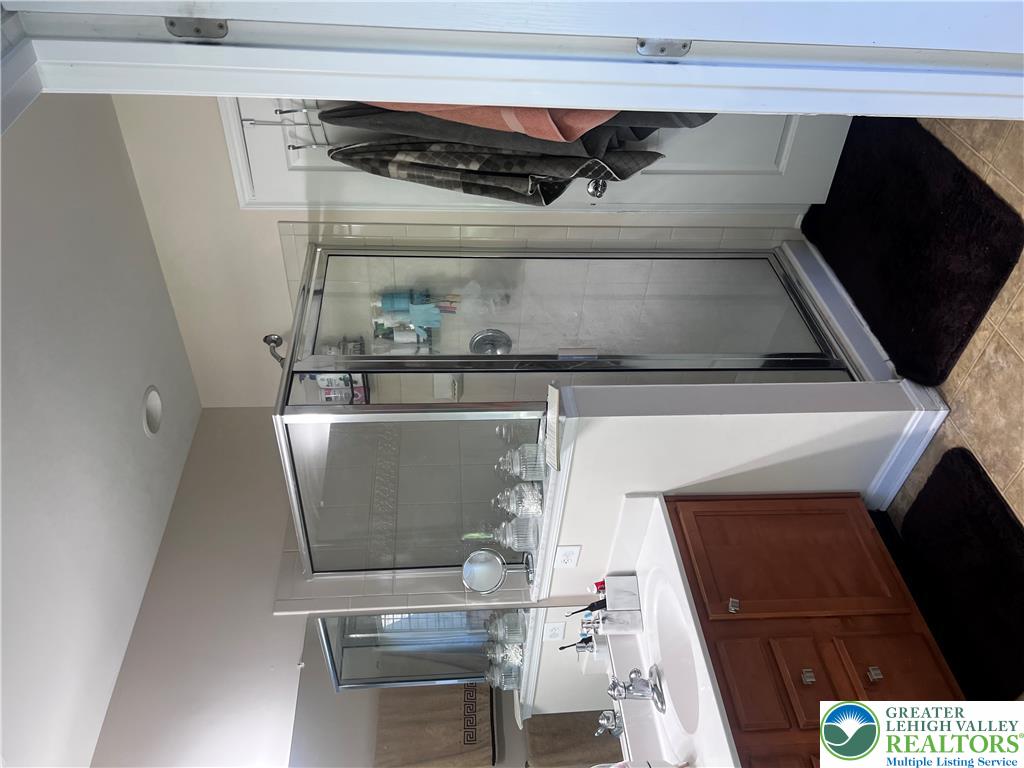 8549 Gateway Road Breinigsville, PA 18031 - Photo 21 of 26 Functional primary bathroom with walk-in shower and ample vanity space for daily routines.