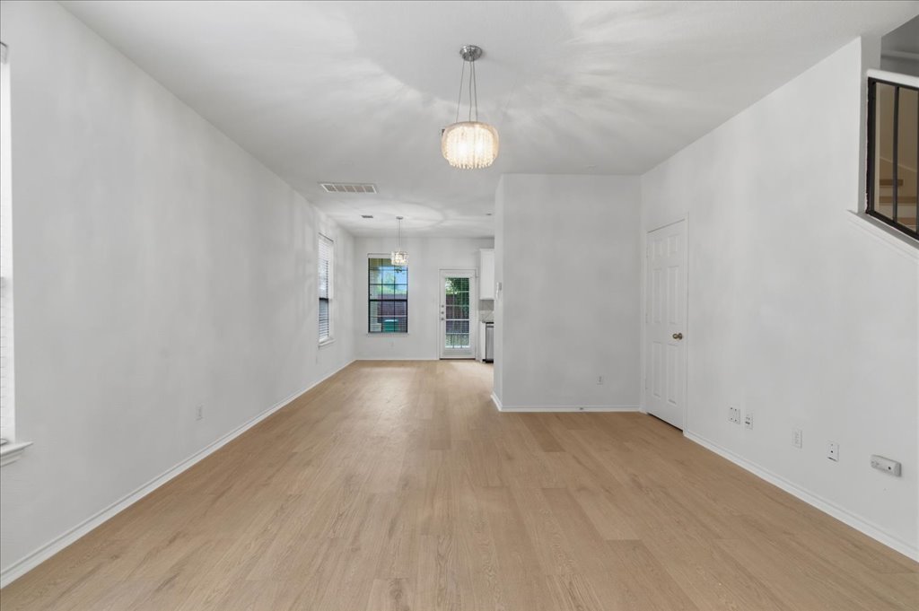 14815 Avery Ranch Boulevard, Unit 302 Austin, TX 78717 - Photo 14 of 30 an empty room with wooden floor and windows