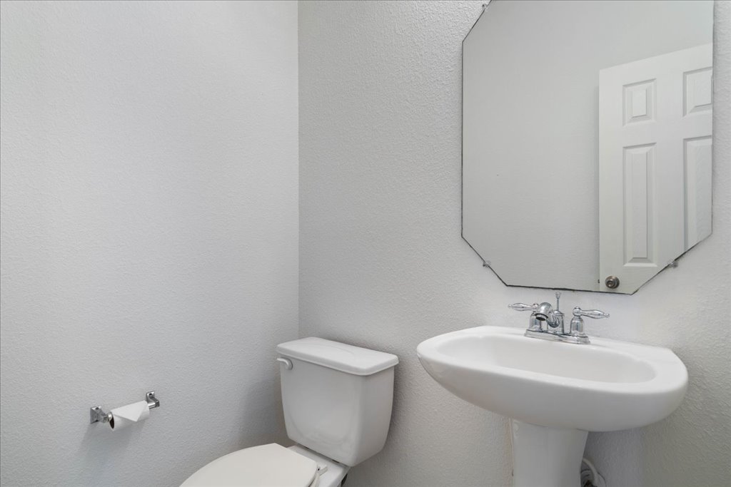 14815 Avery Ranch Boulevard, Unit 302 Austin, TX 78717 - Photo 16 of 30 a bathroom with a sink a toilet and mirror