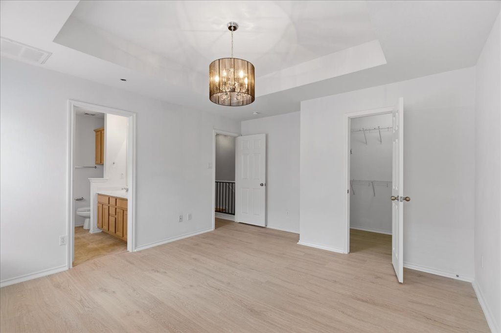 14815 Avery Ranch Boulevard, Unit 302 Austin, TX 78717 - Photo 17 of 30 an empty room with a chandelier