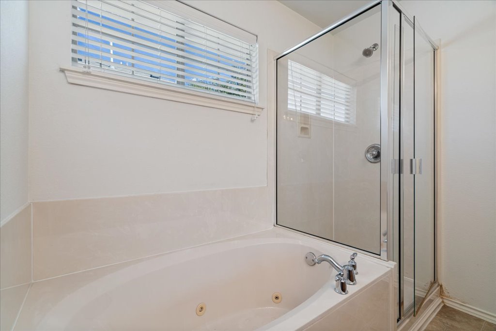 14815 Avery Ranch Boulevard, Unit 302 Austin, TX 78717 - Photo 20 of 30 a bathroom with a bathtub and a shower