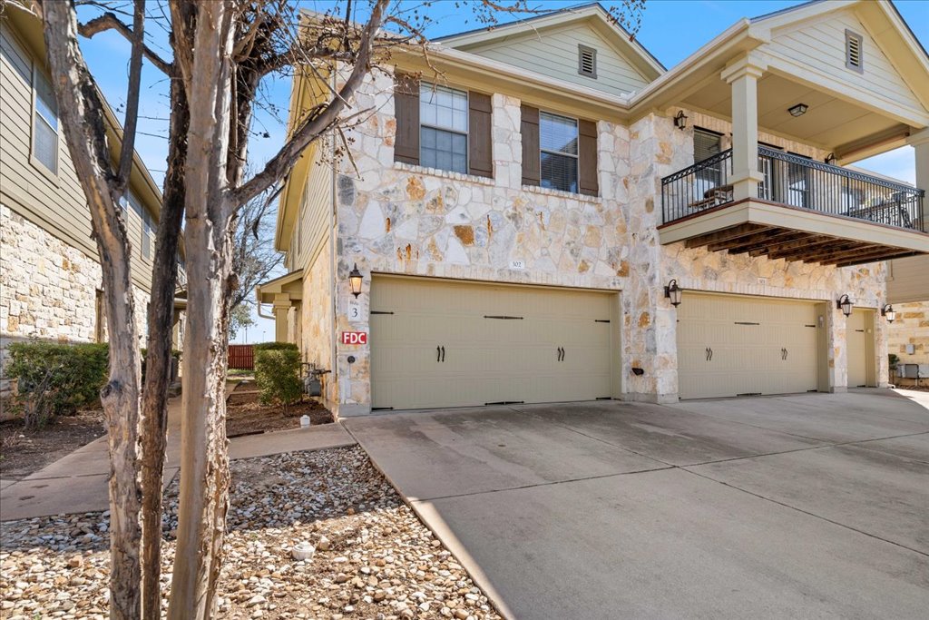 14815 Avery Ranch Boulevard, Unit 302 Austin, TX 78717 - Photo 5 of 30 a view of a white house with a large tree