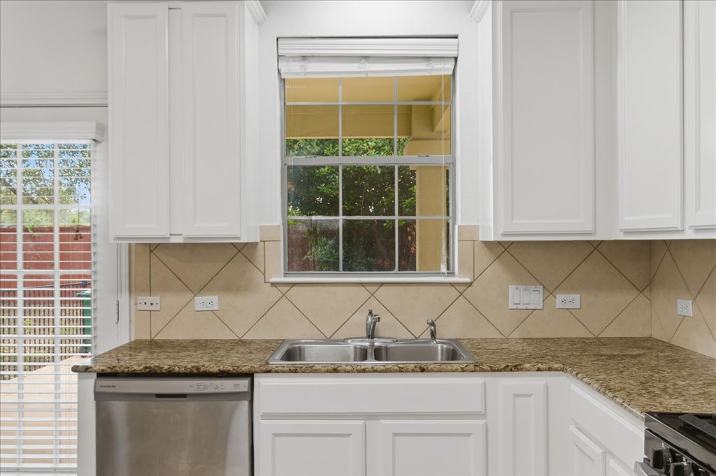 14815 Avery Ranch Boulevard, Unit 302 Austin, TX 78717 - Photo 9 of 30 a kitchen with granite countertop cabinets and window