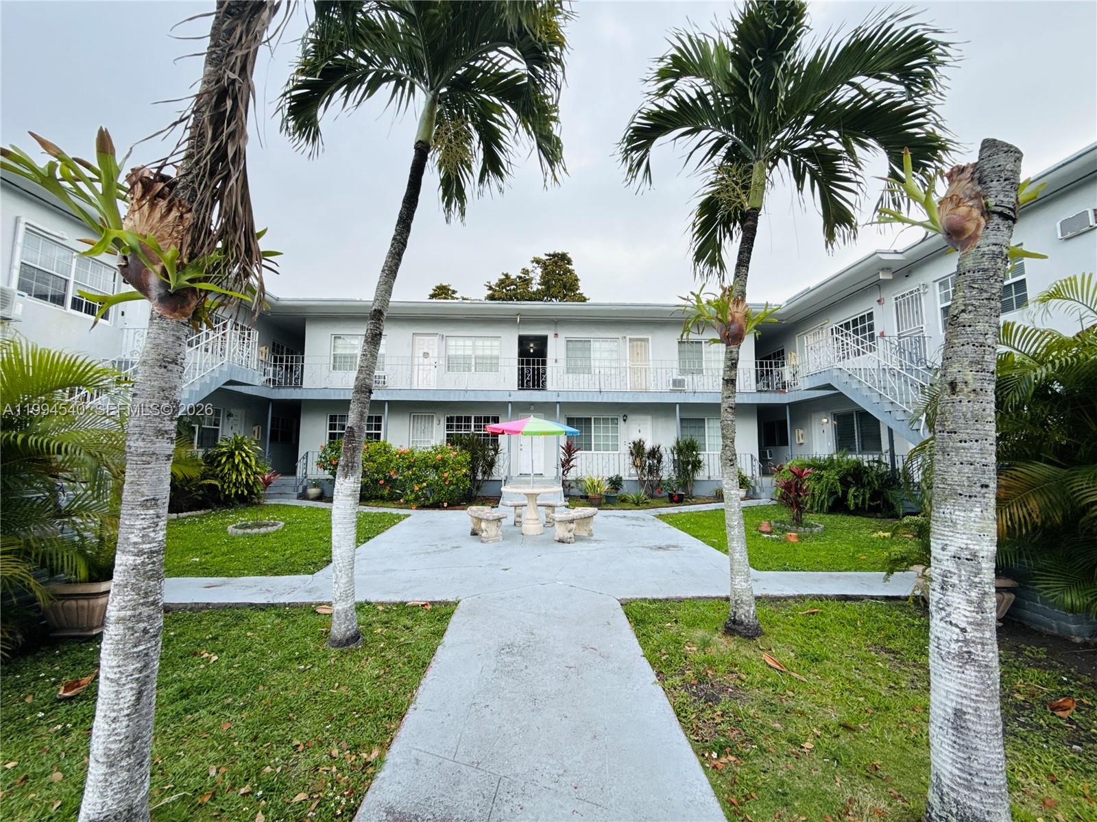 555 Southwest 16th Avenue, Unit 11 Miami, FL 33135 - Photo 1 of 18 a front view of a house with garden and porch