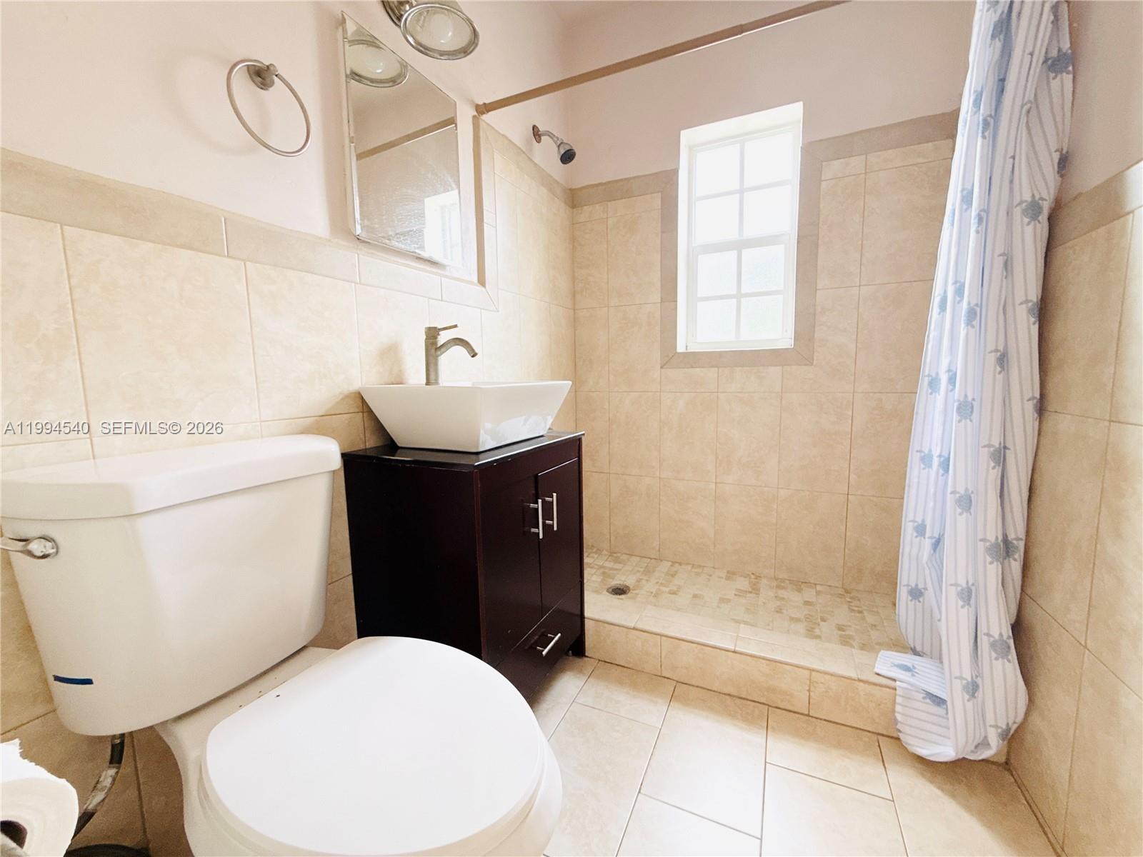 555 Southwest 16th Avenue, Unit 11 Miami, FL 33135 - Photo 11 of 18 a bathroom with a sink toilet and shower