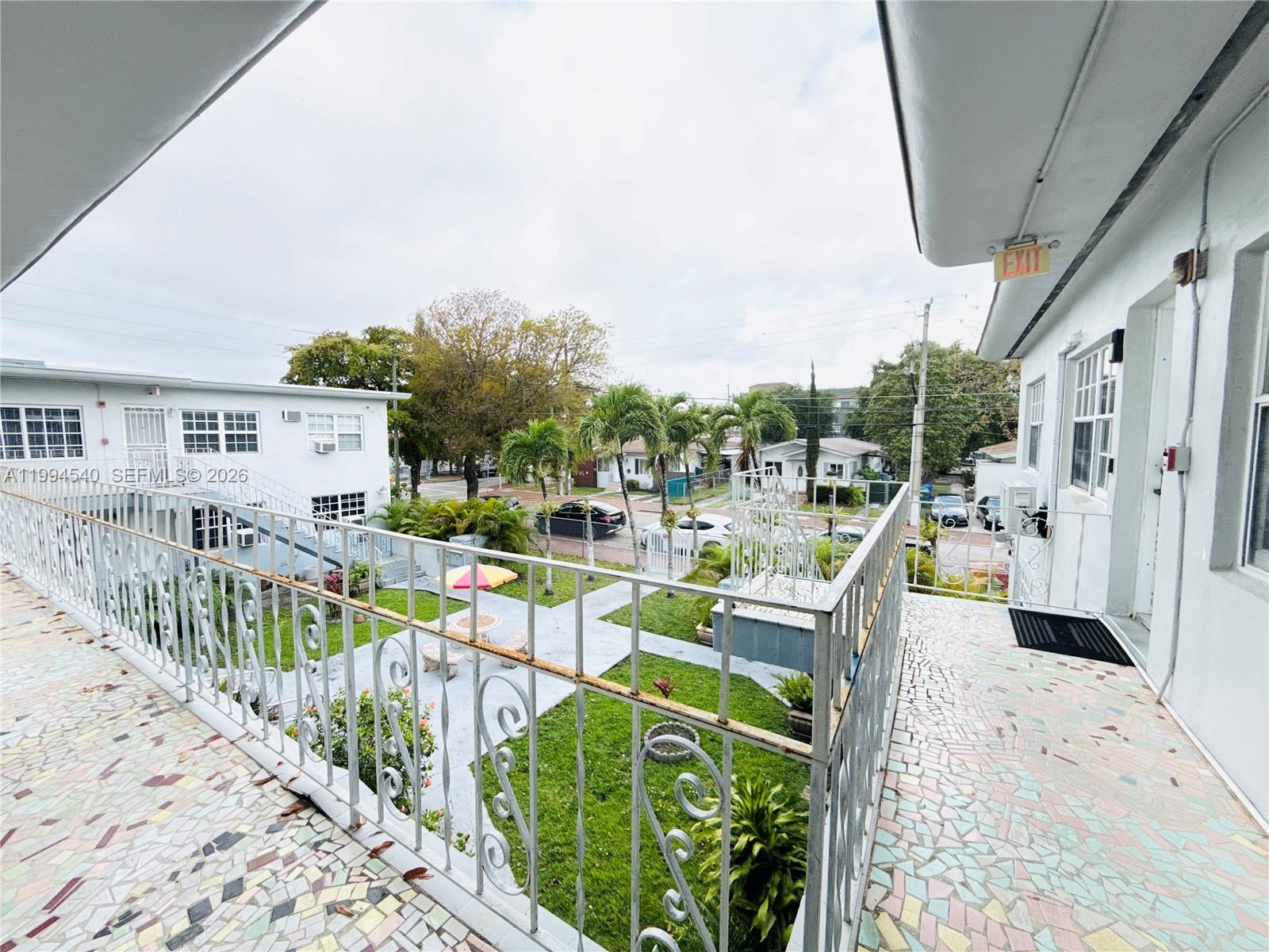 555 Southwest 16th Avenue, Unit 11 Miami, FL 33135 - Photo 16 of 18 a view of a chair and tables in the balcony