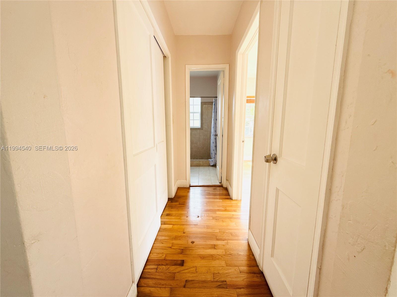 555 Southwest 16th Avenue, Unit 11 Miami, FL 33135 - Photo 5 of 18 a view of a hallway with wooden floor