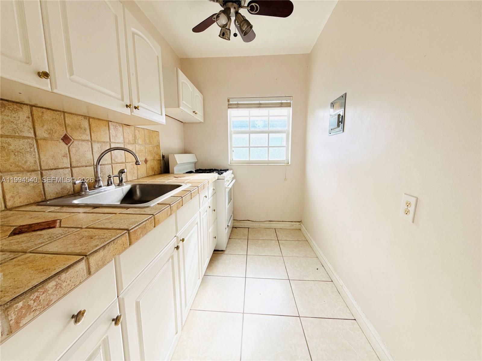 555 Southwest 16th Avenue, Unit 11 Miami, FL 33135 - Photo 6 of 18 a kitchen with a sink and cabinets