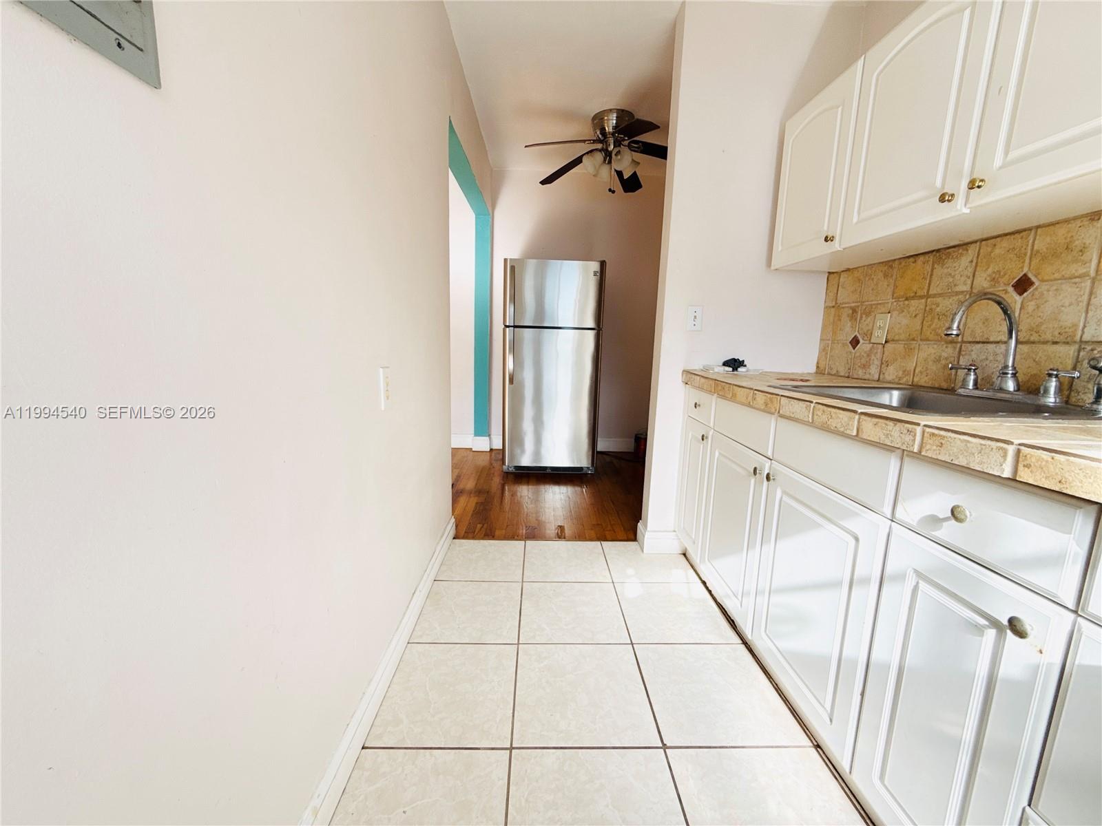 555 Southwest 16th Avenue, Unit 11 Miami, FL 33135 - Photo 8 of 18 a kitchen with a sink and cabinets