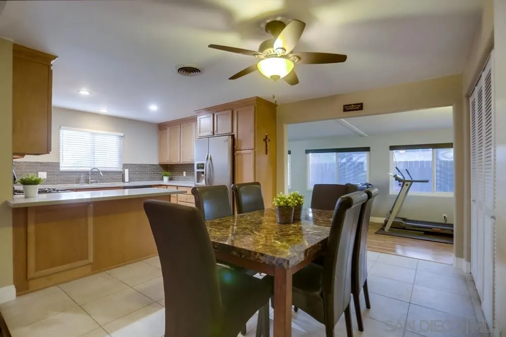 13626 Carriage Road Poway, CA 92064 - Photo 5 of 25 a dining room with furniture a window and kitchen view