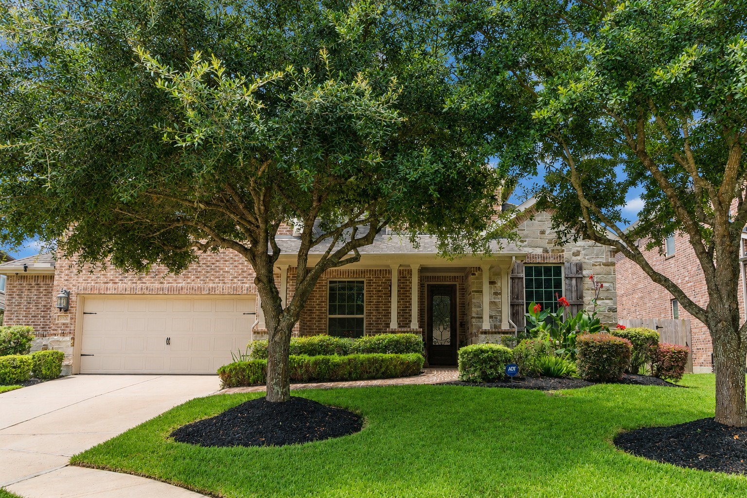 2326 Hamilton Pool Lane Friendswood, TX 77546 - Photo 2 of 49 a front view of a house with a yard and a tree