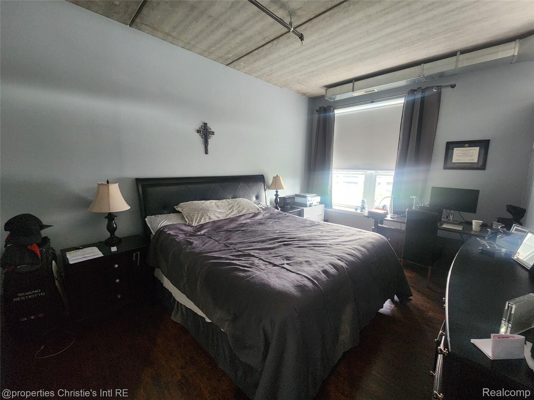 66 Winder Street, Unit 458 Detroit, MI 48201 - Photo 8 of 19 Bedroom featuring dark wood-type flooring and an office area