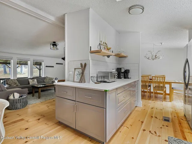 a view of a dining room with furniture wooden floor and a chandelier