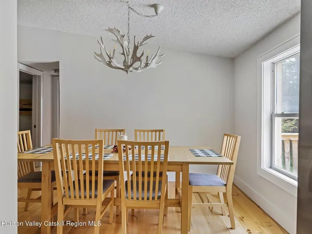 a view of a dining room with furniture and window