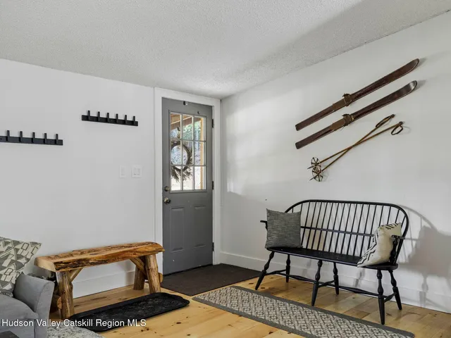 a view of a hallway with wooden floor and dining room