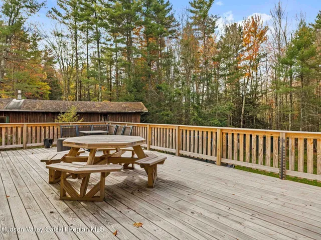 swimming pool with outdoor seating and green space