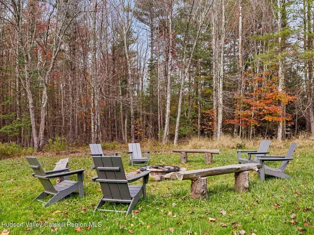 a backyard of a house with table and chairs