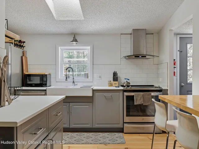 a kitchen with cabinets a sink and appliances