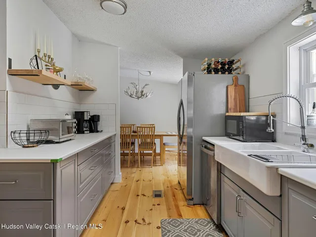 a kitchen with a sink stove and refrigerator