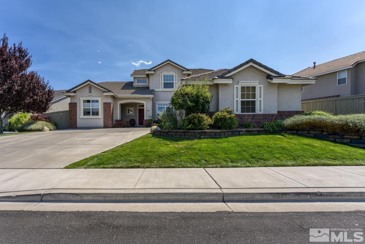 10650 Silver Cliff Way Reno, NV 89521 - Photo 1 of 38 a front view of a house with a yard