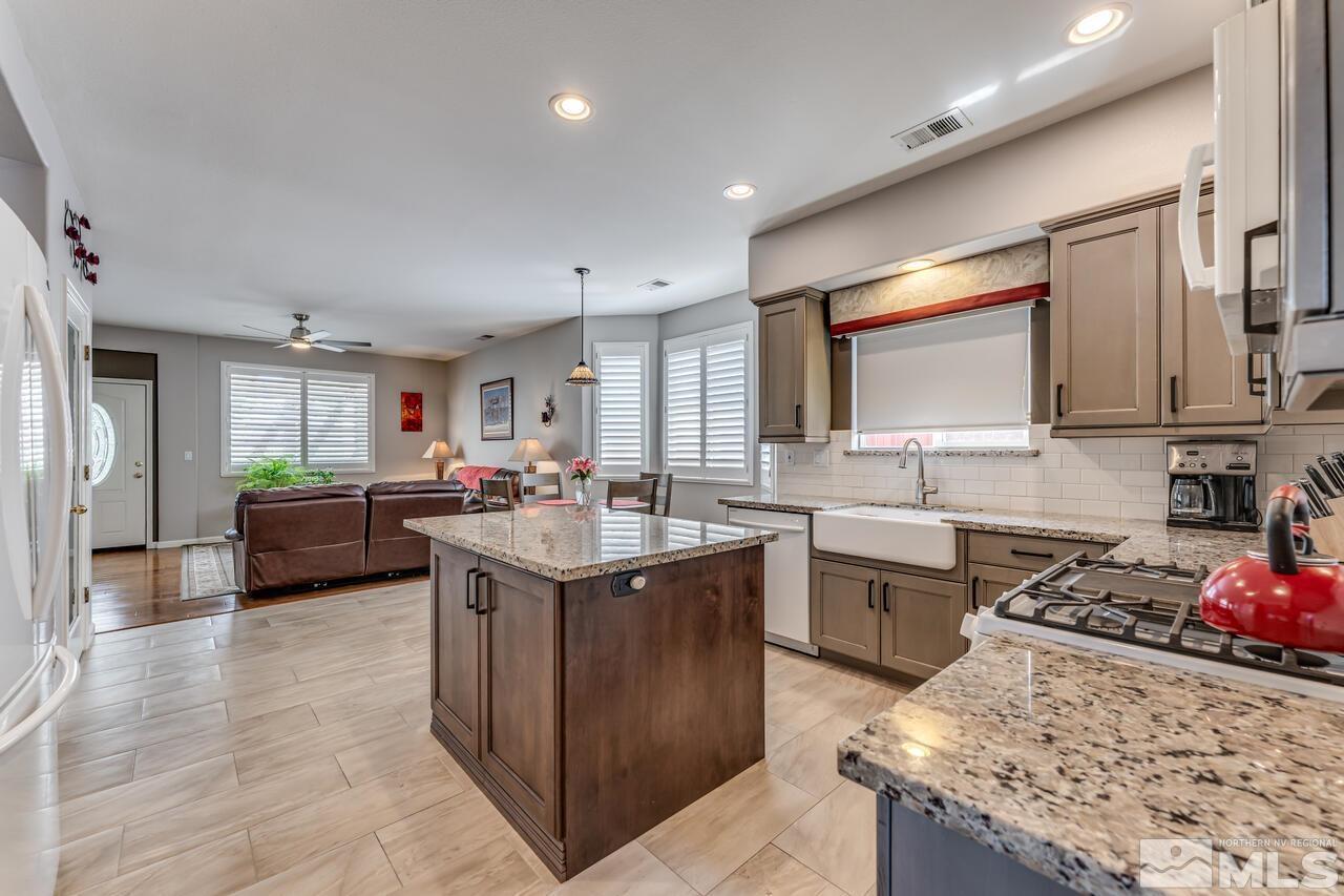 10650 Silver Cliff Way Reno, NV 89521 - Photo 11 of 38 a kitchen with sink a stove and cabinets