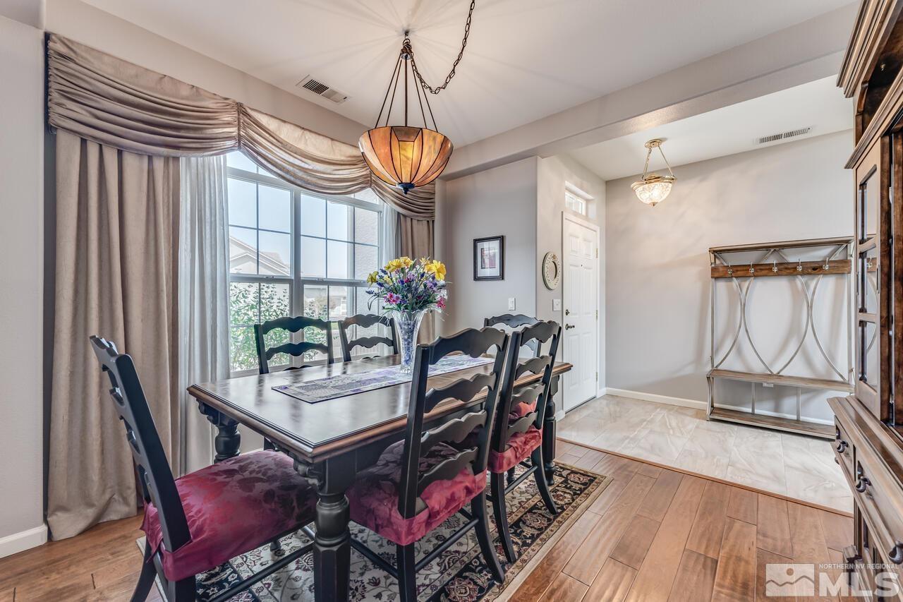10650 Silver Cliff Way Reno, NV 89521 - Photo 14 of 38 a view of a dining room with furniture window and wooden floor