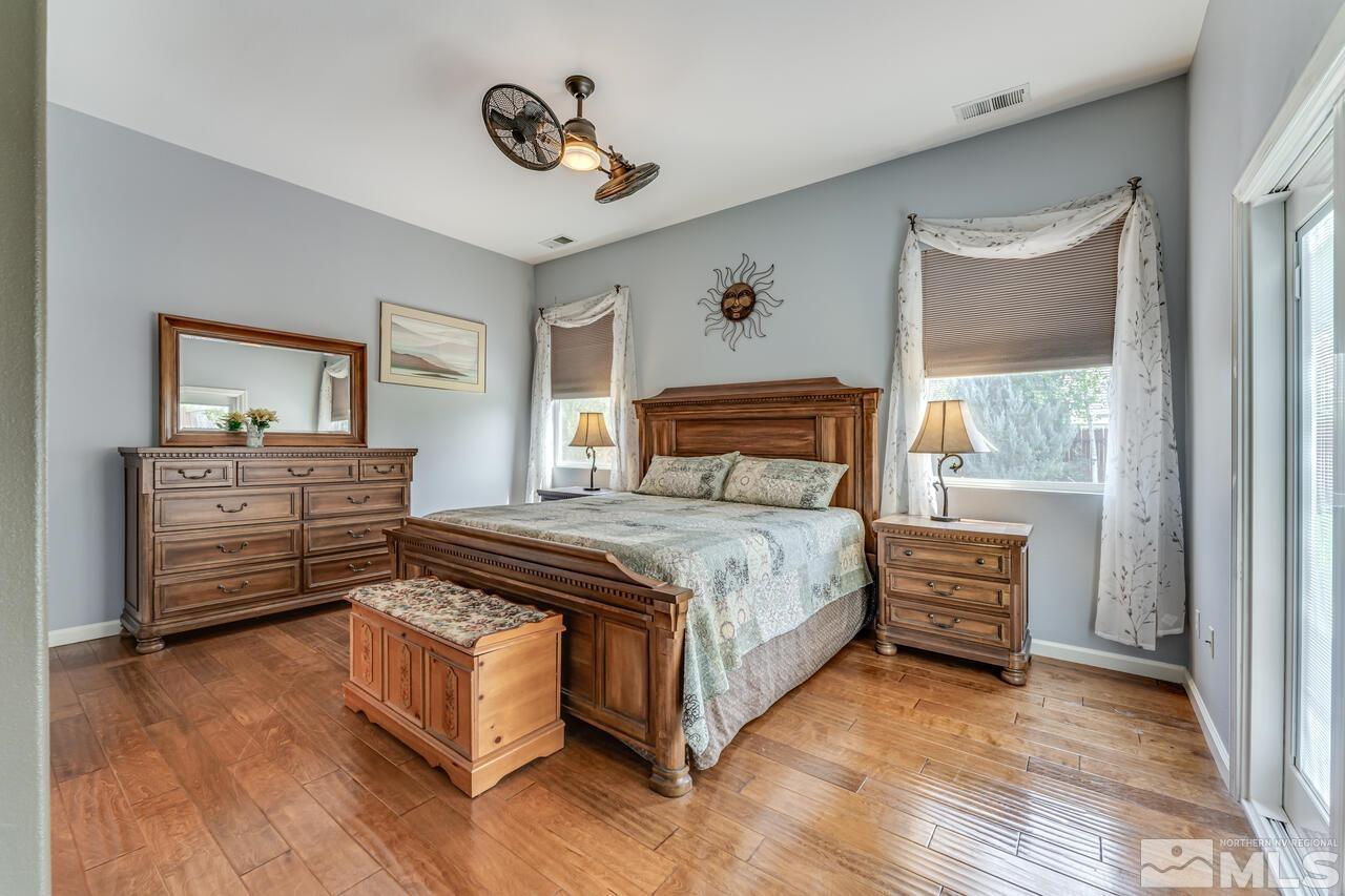 10650 Silver Cliff Way Reno, NV 89521 - Photo 16 of 38 a bedroom with a bed and a dresser next to a window