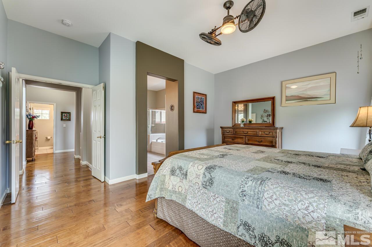10650 Silver Cliff Way Reno, NV 89521 - Photo 17 of 38 a bedroom with a bed and wooden floor