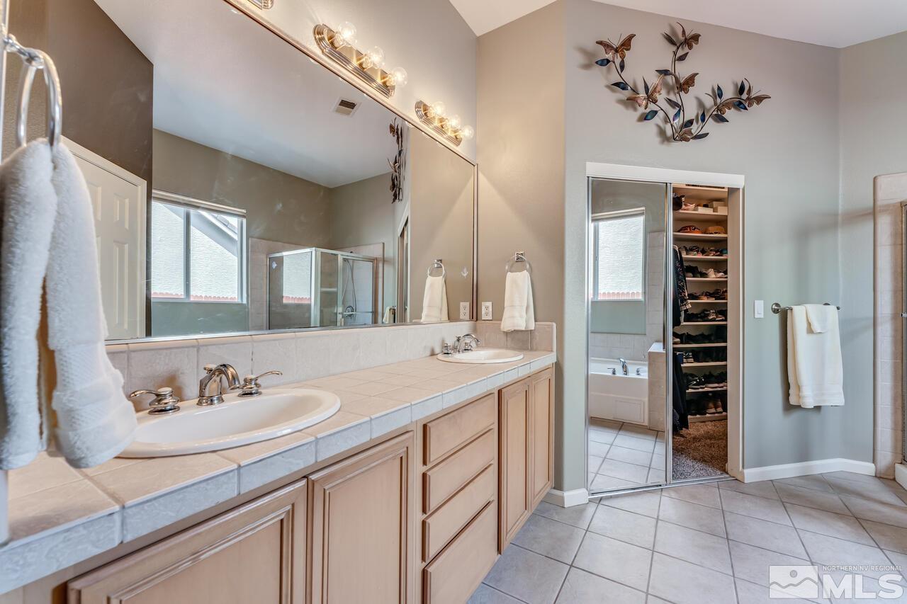 10650 Silver Cliff Way Reno, NV 89521 - Photo 18 of 38 a bathroom with a sink and a mirror