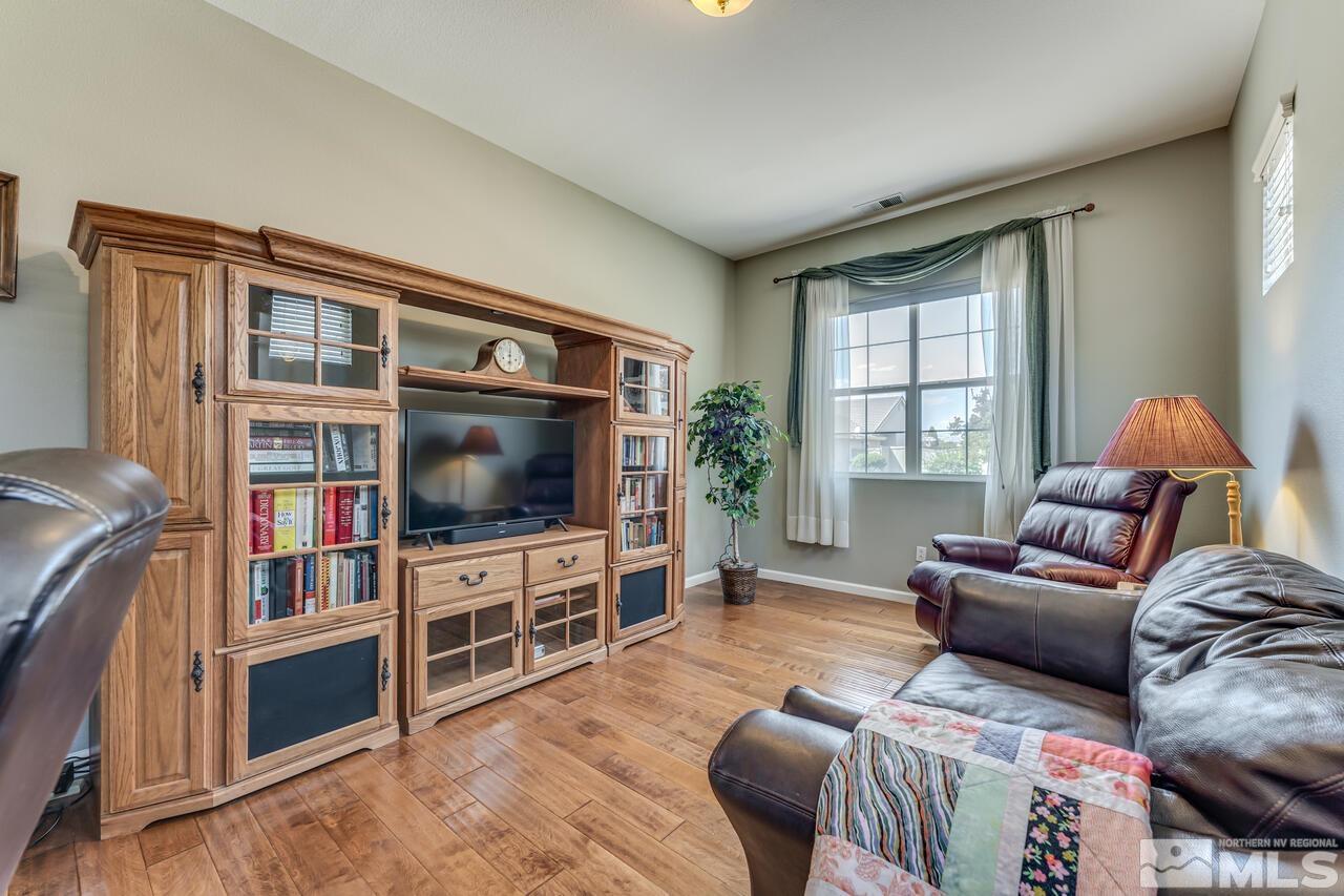 10650 Silver Cliff Way Reno, NV 89521 - Photo 22 of 38 a living room with furniture and a flat screen tv