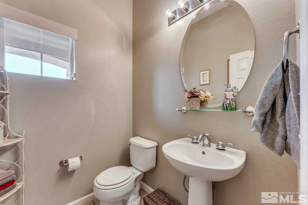 10650 Silver Cliff Way Reno, NV 89521 - Photo 23 of 38 a bathroom with a sink toilet and mirror