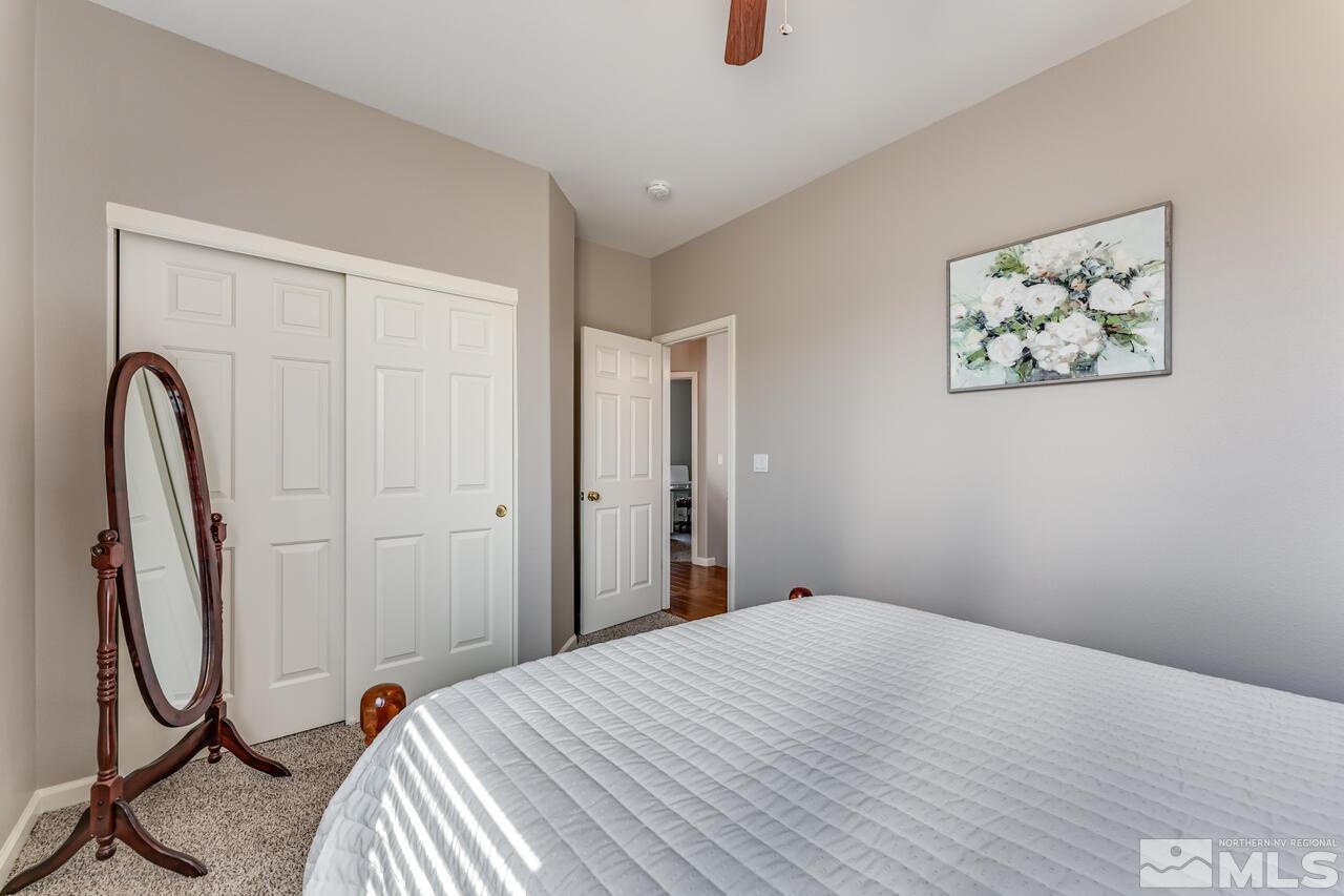 10650 Silver Cliff Way Reno, NV 89521 - Photo 27 of 38 a bedroom with a bed and a window