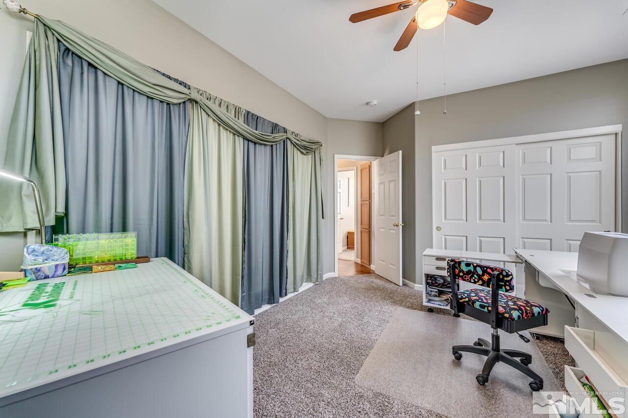 10650 Silver Cliff Way Reno, NV 89521 - Photo 29 of 38 a bed room with a bed window and a chandelier