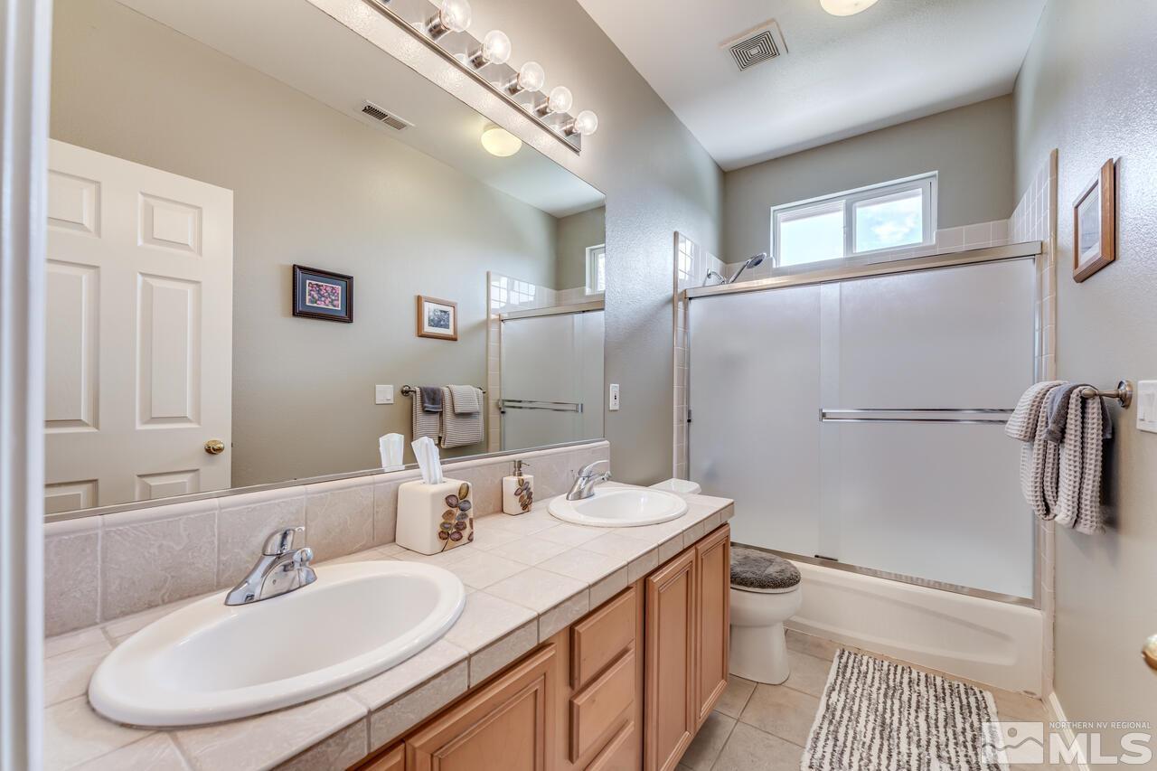 10650 Silver Cliff Way Reno, NV 89521 - Photo 30 of 38 a bathroom with a sink toilet and shower