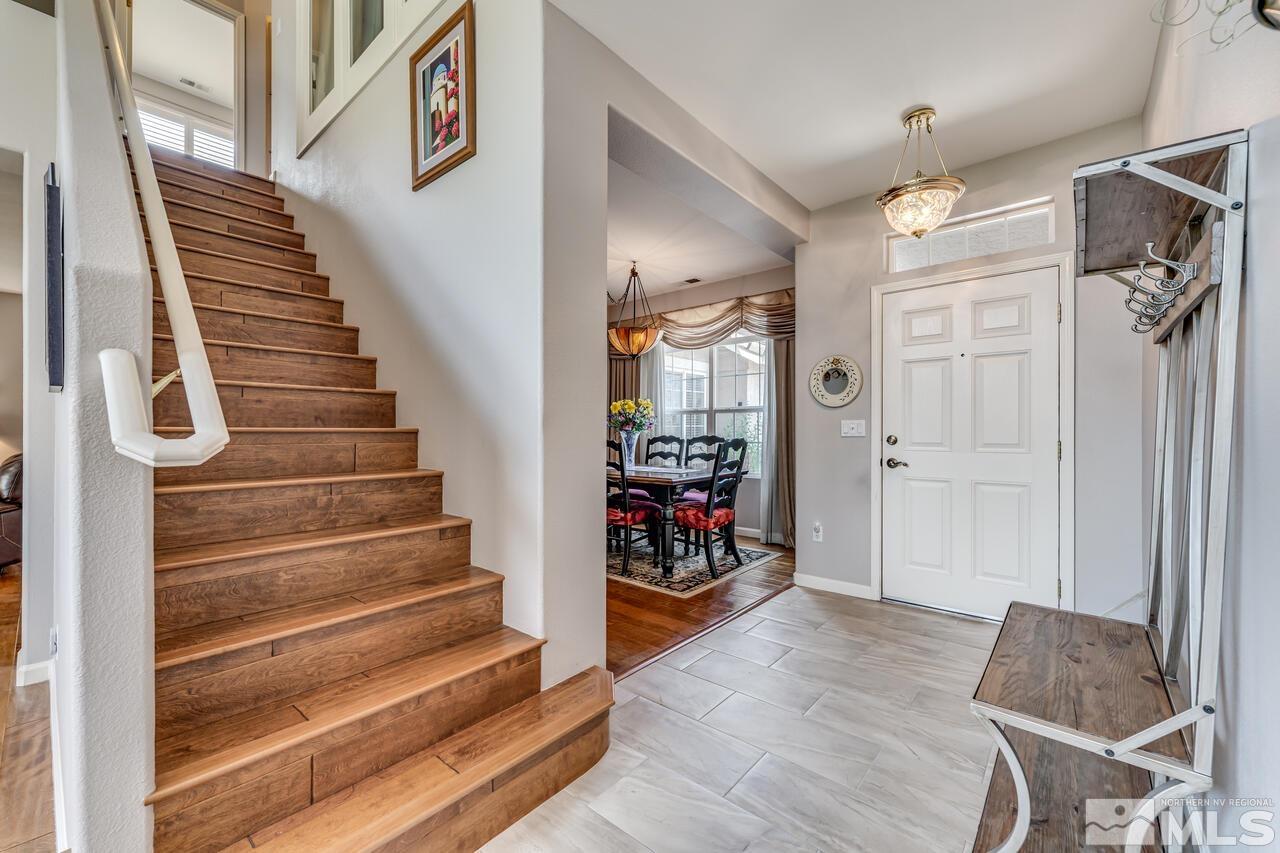 10650 Silver Cliff Way Reno, NV 89521 - Photo 3 of 38 a view of an entryway with wooden floor and a front door