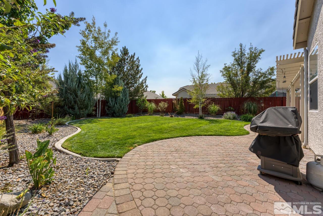 10650 Silver Cliff Way Reno, NV 89521 - Photo 32 of 38 a view of a backyard with a garden and entertaining space