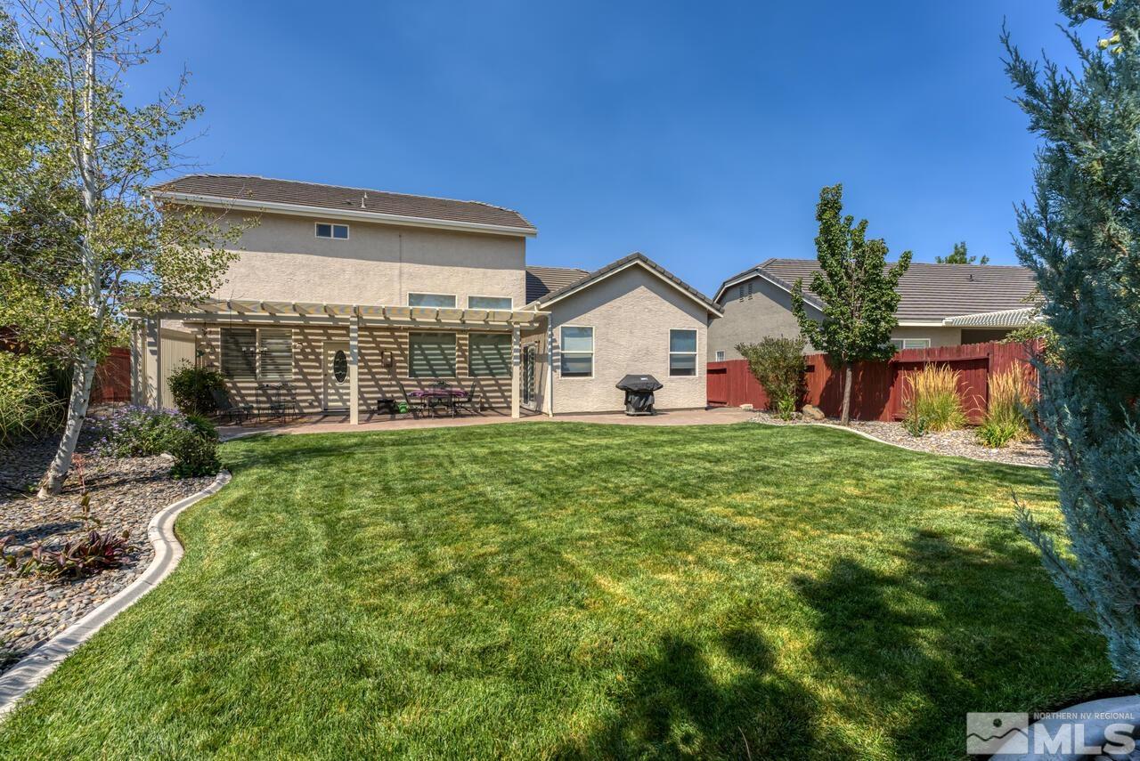 10650 Silver Cliff Way Reno, NV 89521 - Photo 33 of 38 a view of a house with backyard and porch